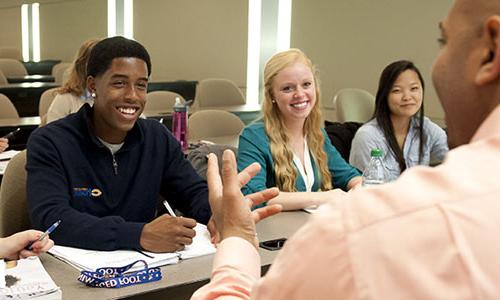 three Carroll University students listening to a lecture.